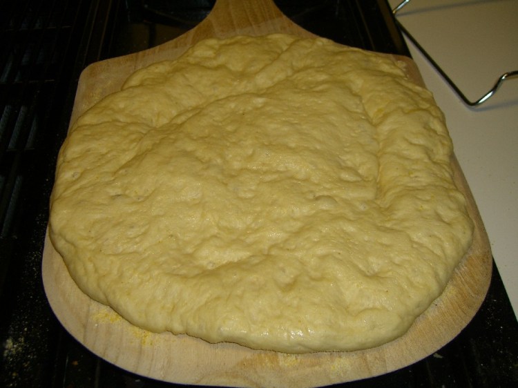 Crust spread on pizza peel